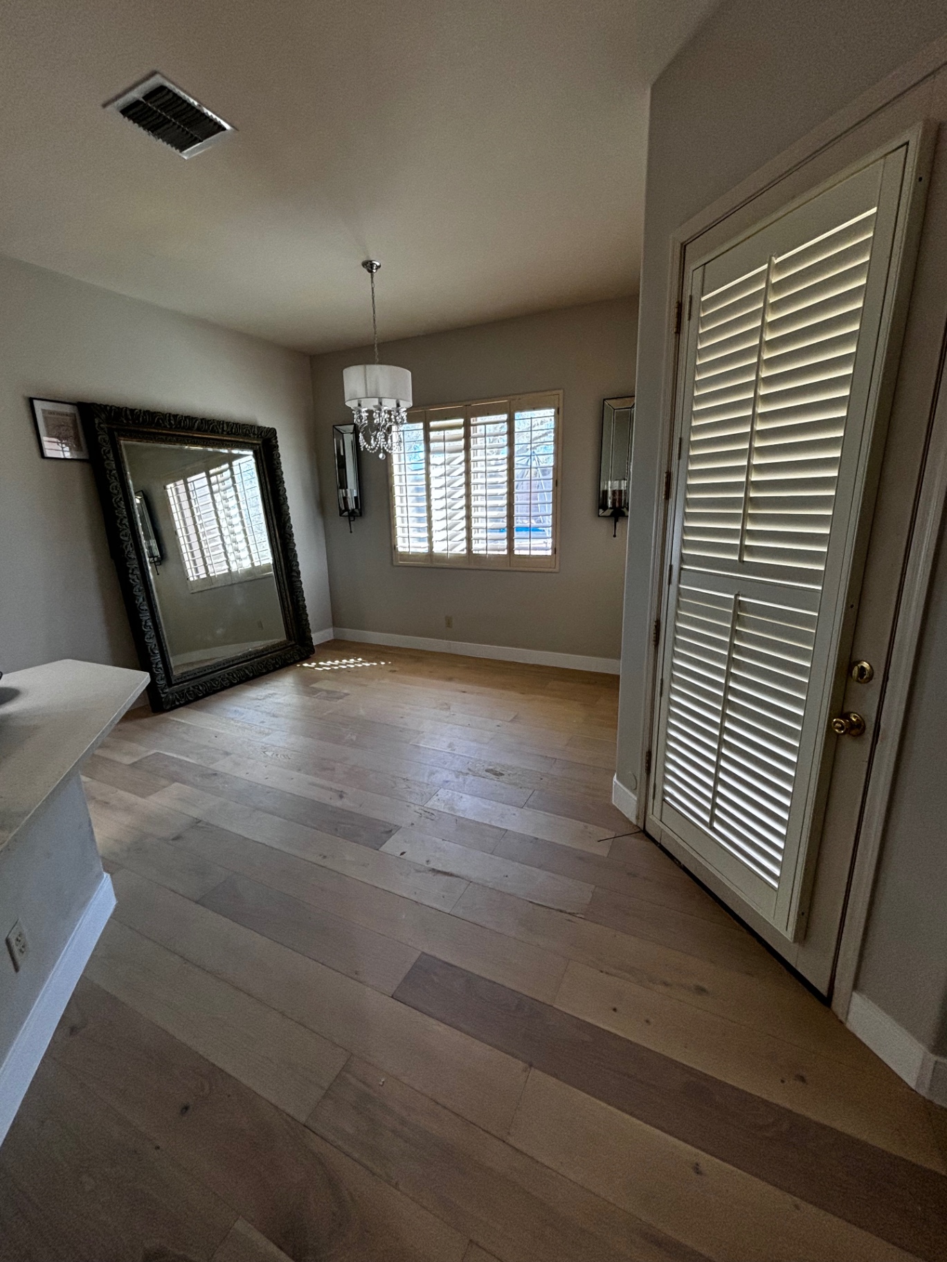 Finished hardwood in dining room with chandelier