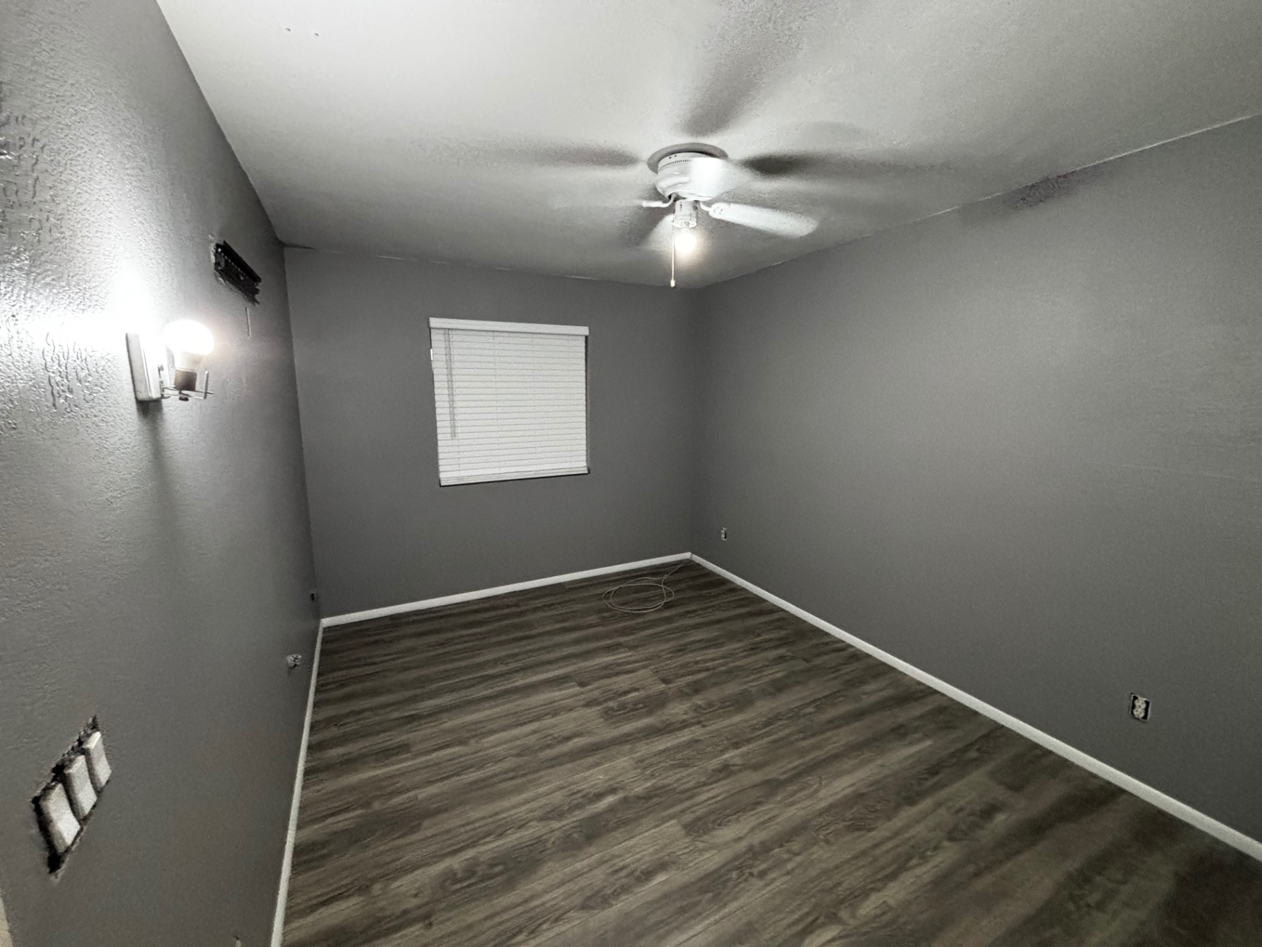 Finished bedroom with new wall sconce and flooring