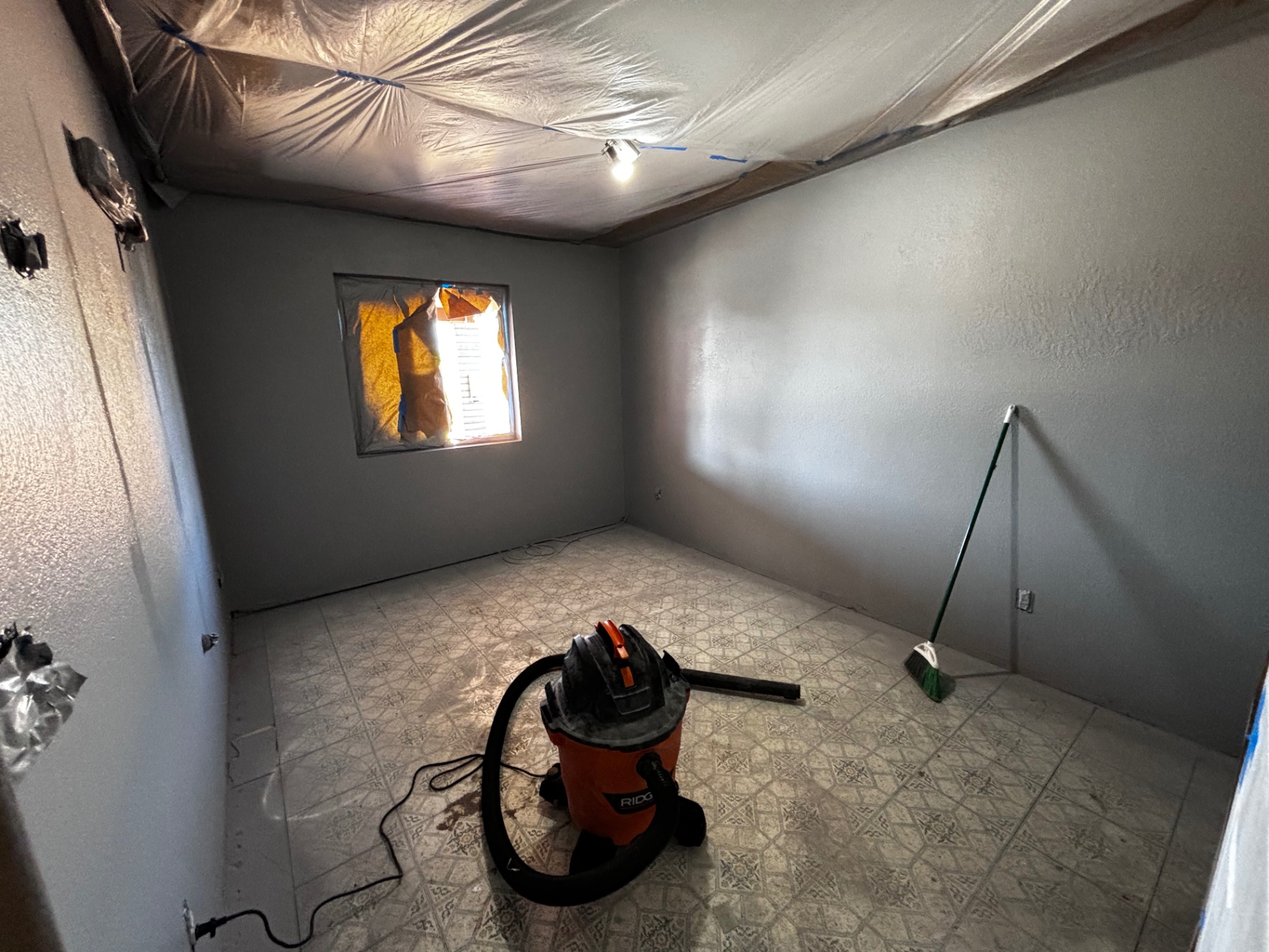 Bedroom with ceiling masked and gray paint applied