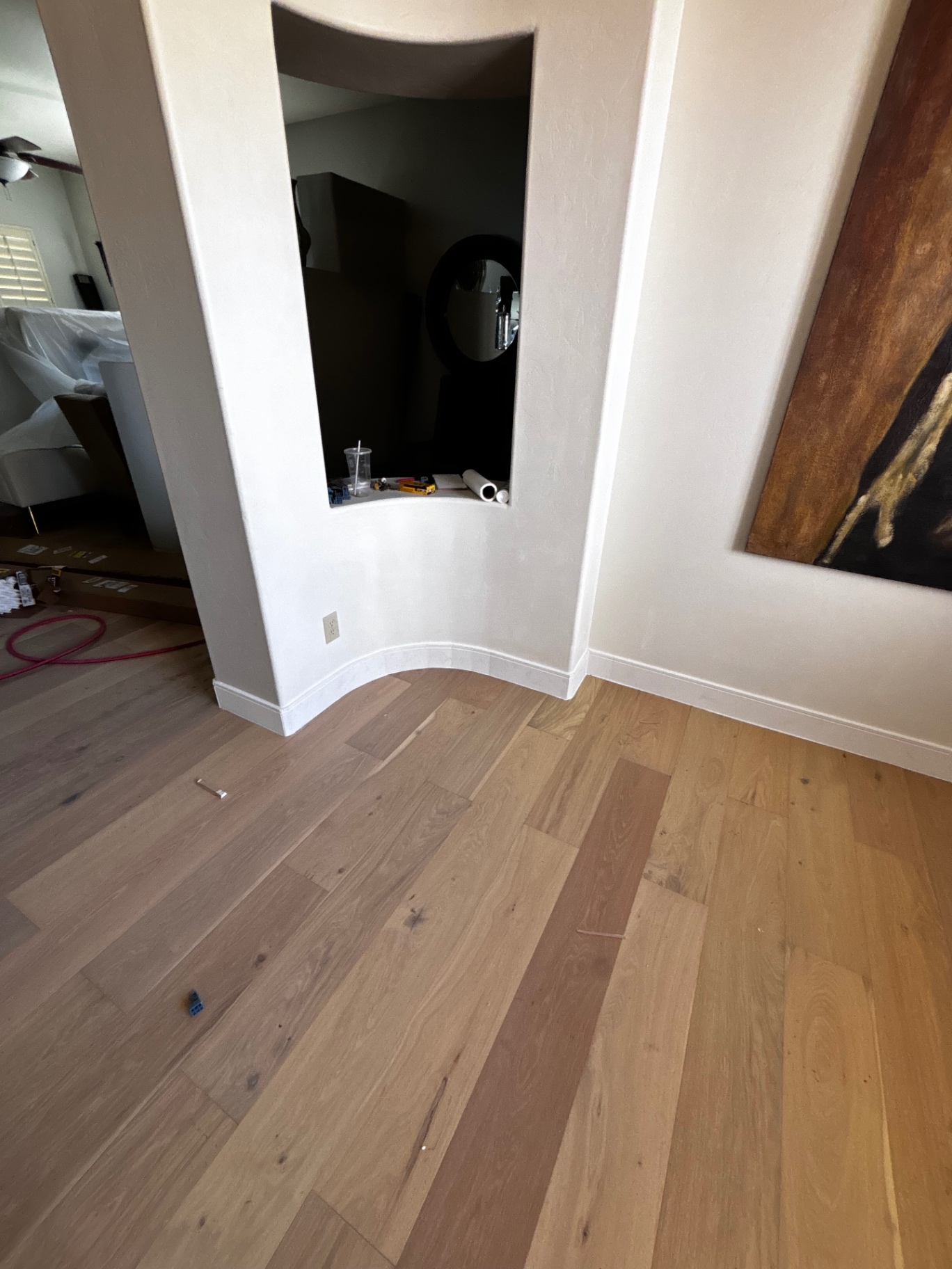 Finished hardwood flooring with new baseboards