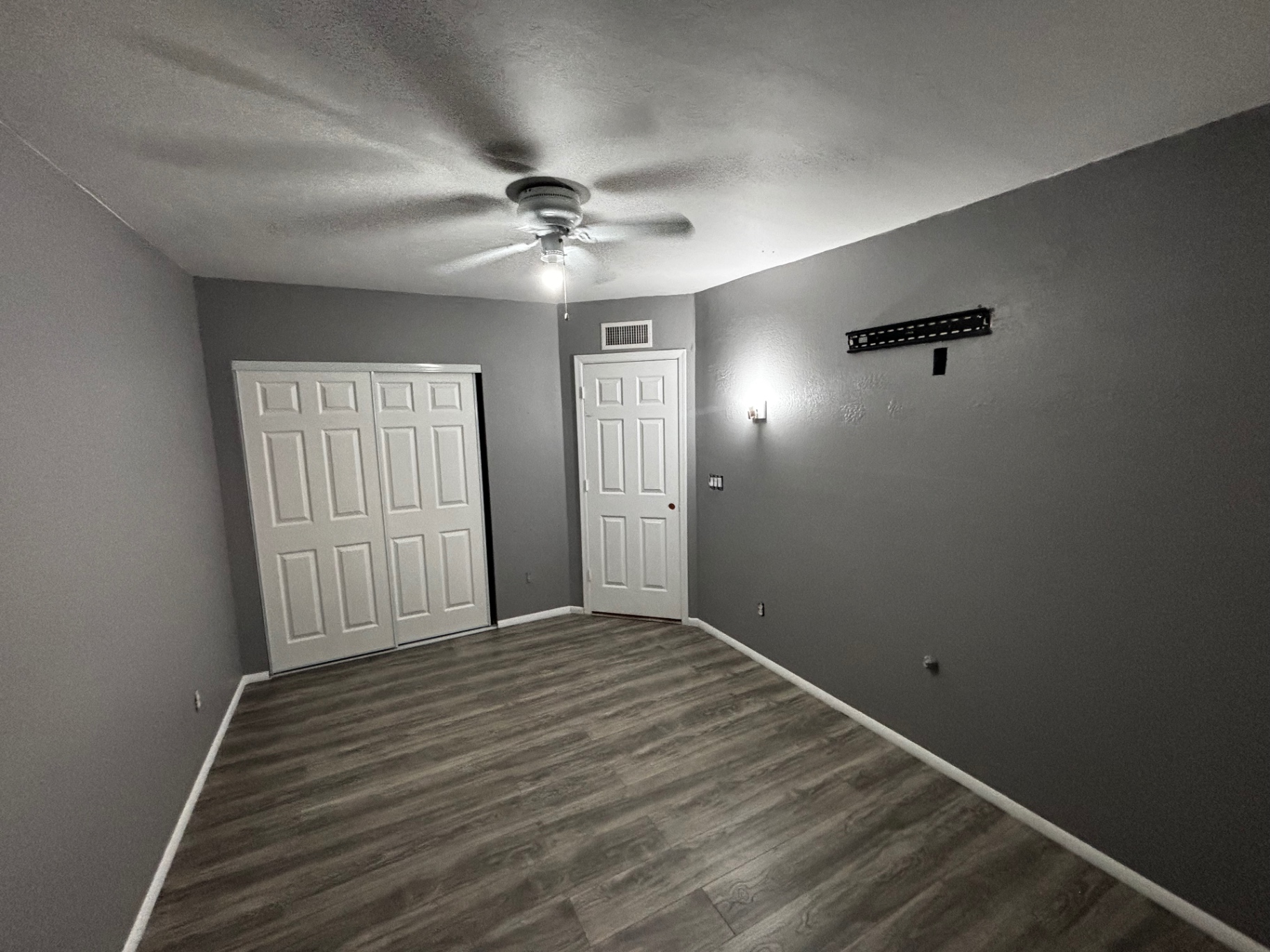 Finished bedroom with new doors, flooring, and paint