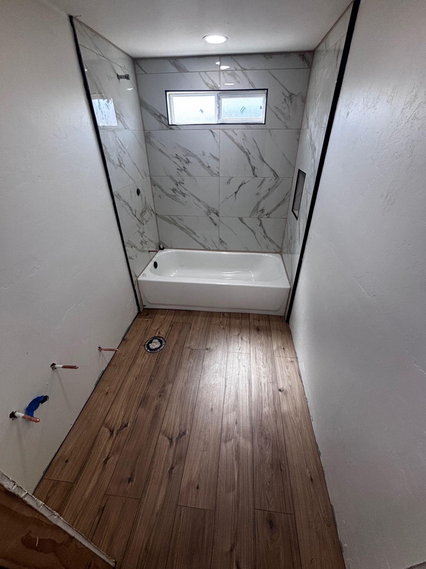 Marble tile shower surround with tub