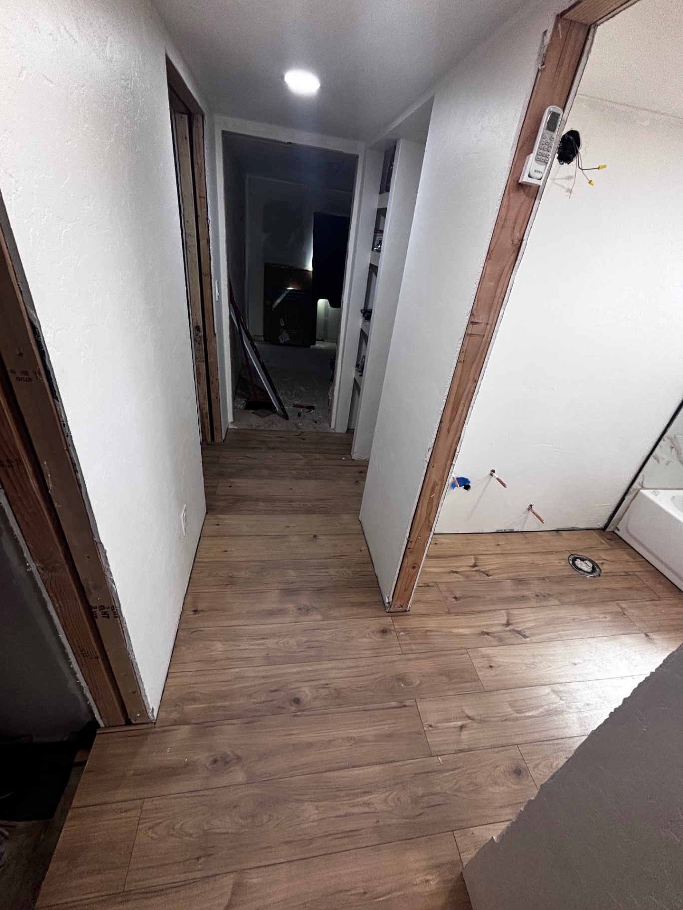 Hallway with new flooring leading to bathroom