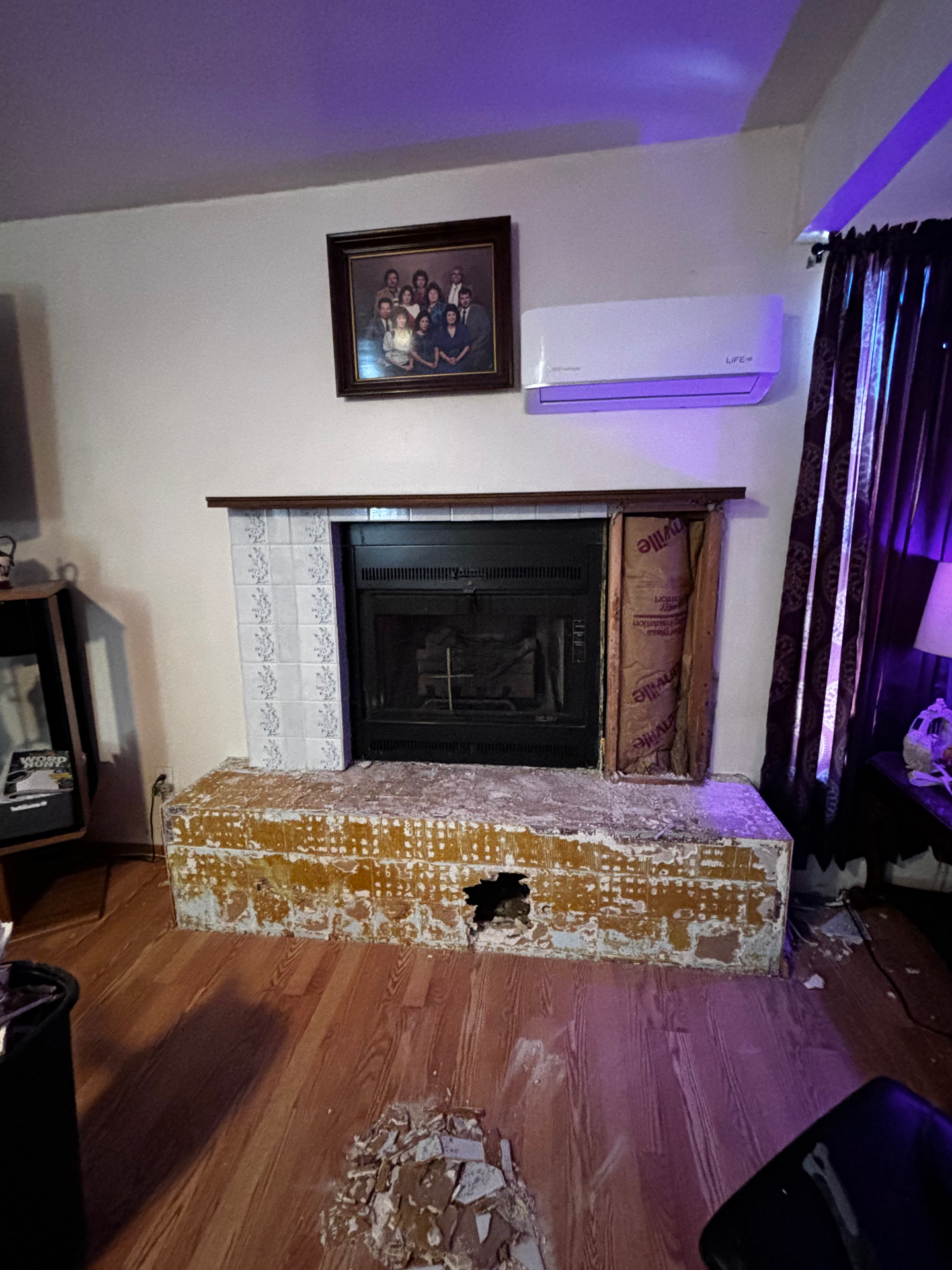 Existing fireplace being demoed during remodel