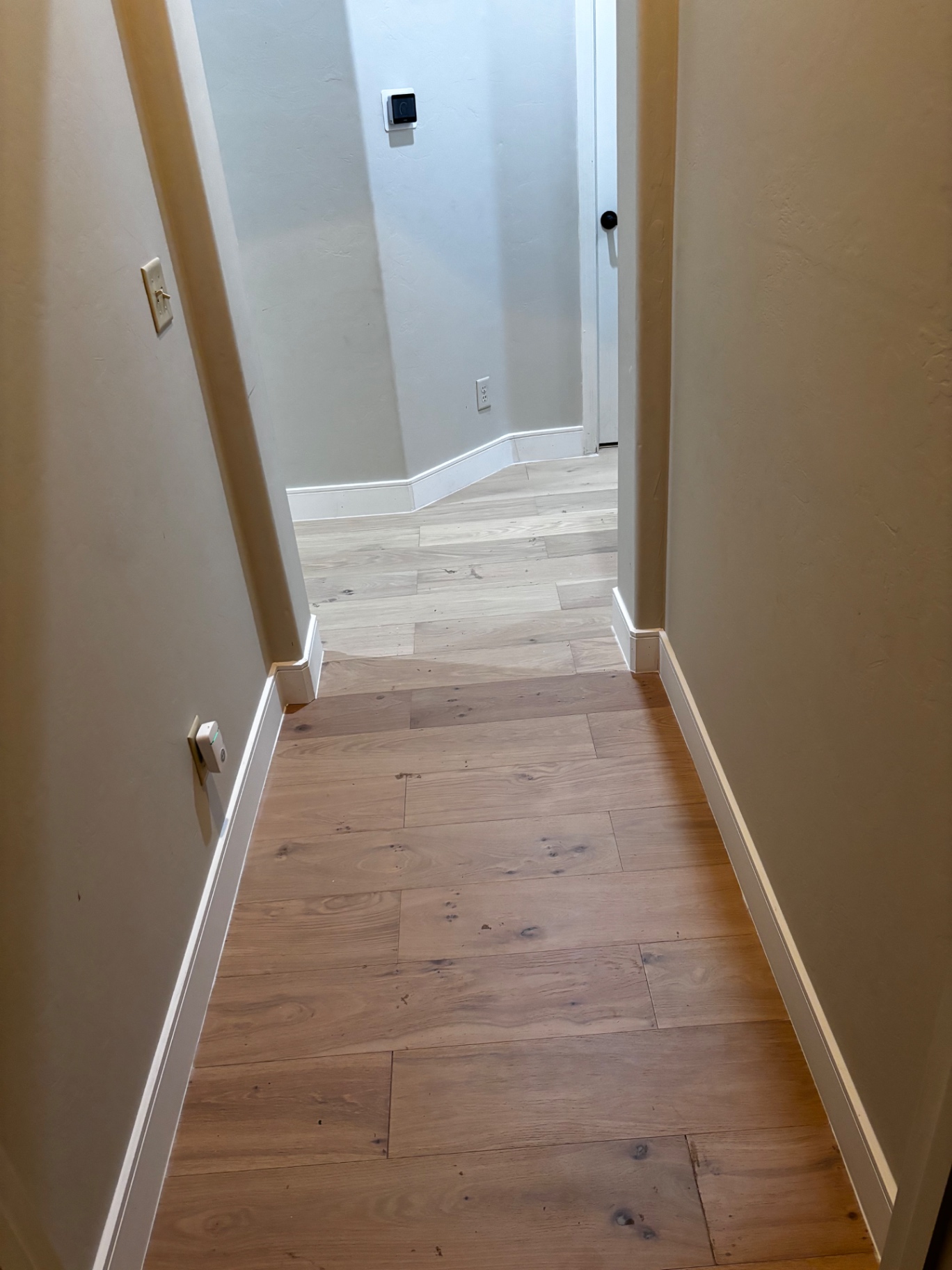 Finished hardwood hallway with new baseboards