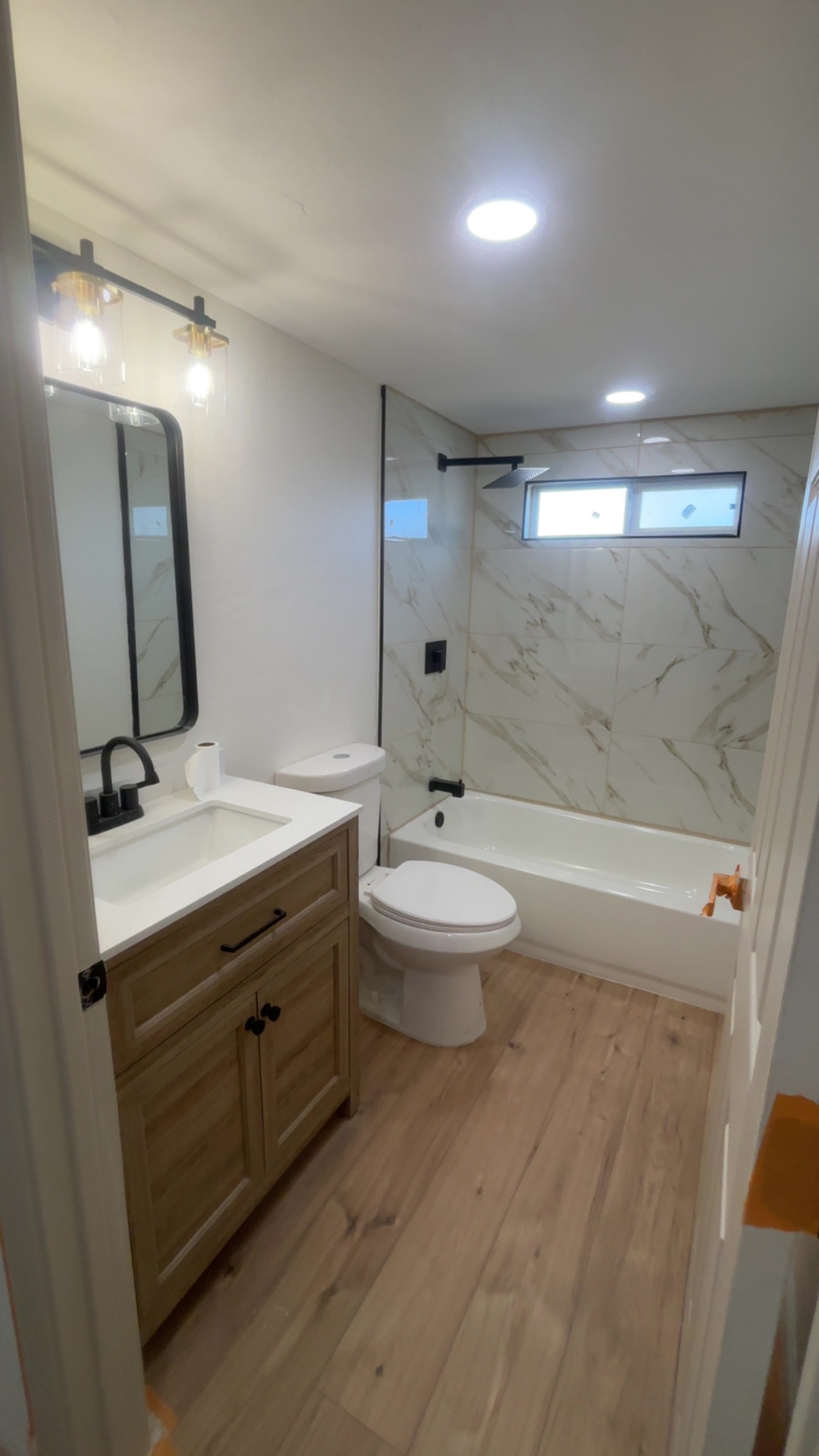 Finished bathroom with vanity, tub and tile