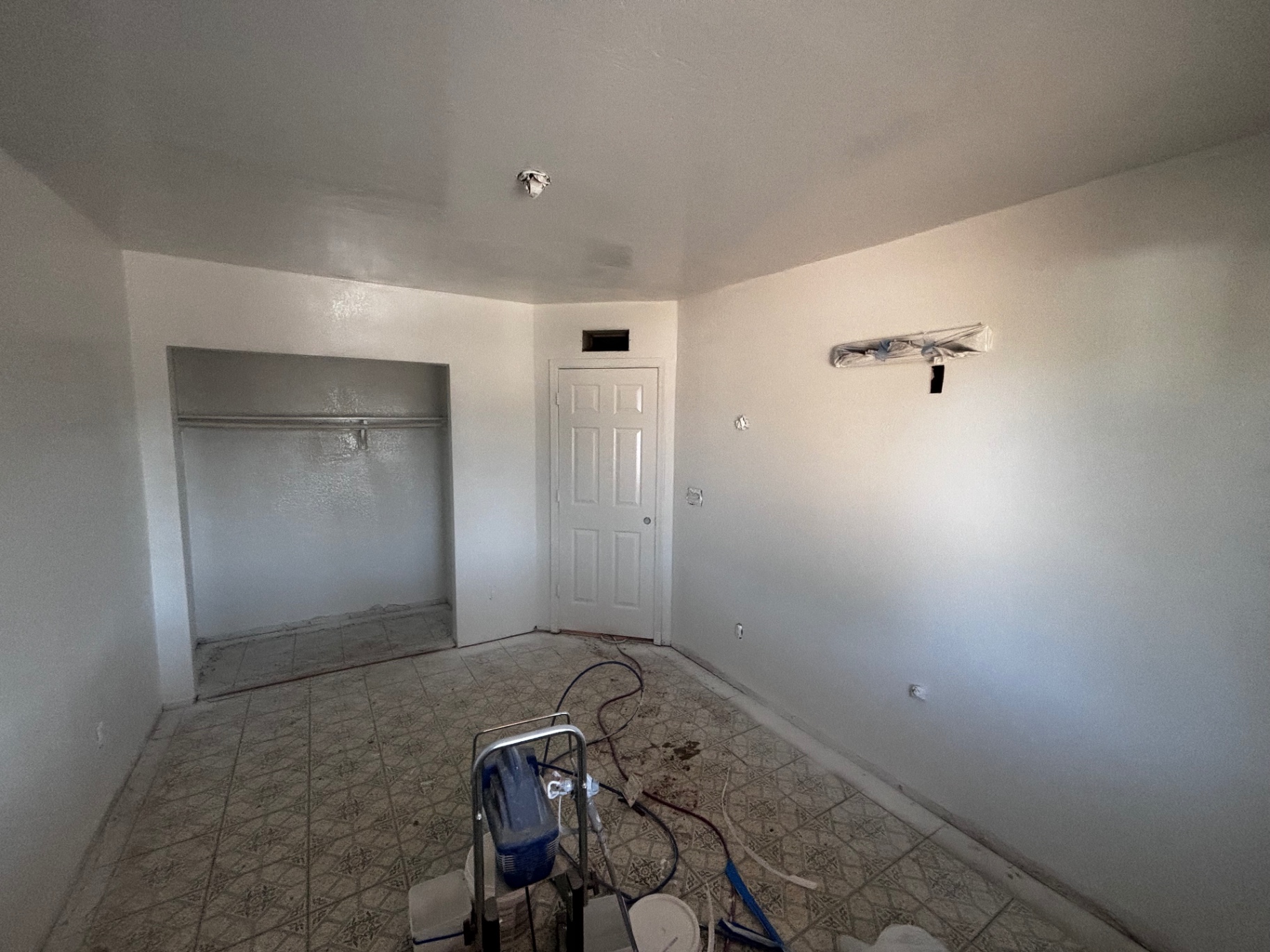 Bedroom with primer and old tile floor